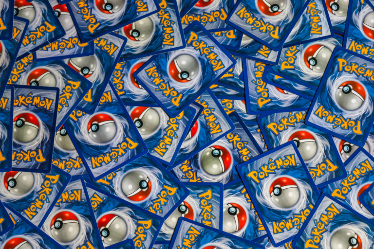 A vibrant collection of Pokemon trading cards featuring iconic Pokeball design and Pokemon logo.