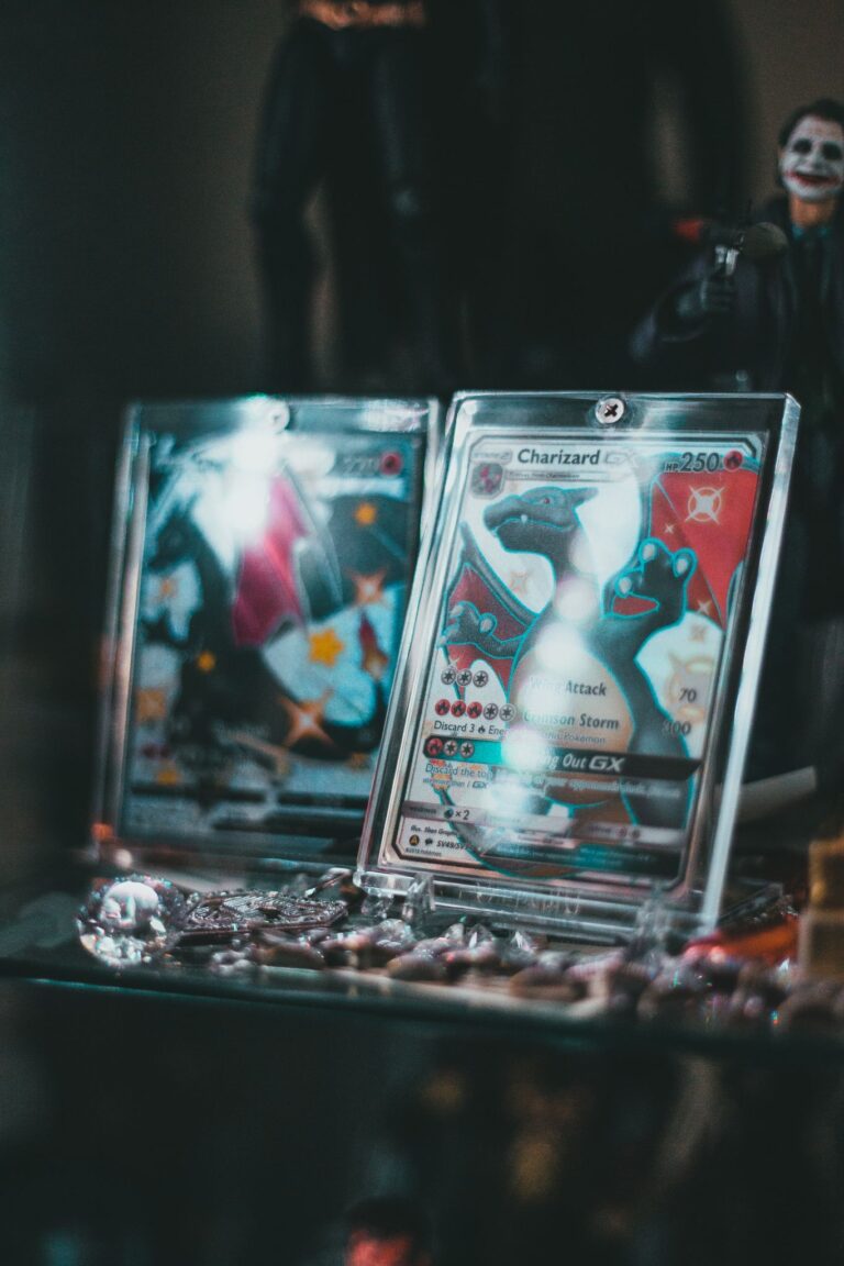 Close-up of collectible Pokemon trading cards in protective cases on display.